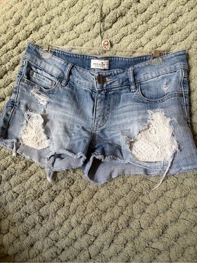 Bootlegger Light Blue Distressed Denim Crochet-Accent Shorts